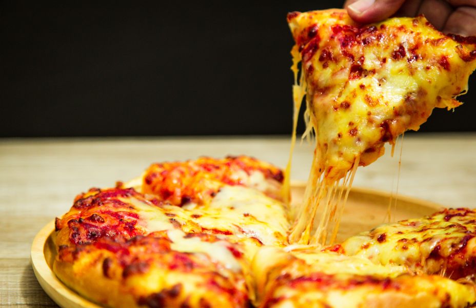 a slice of pizza being picked up